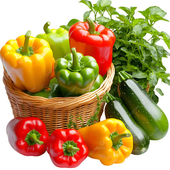 Fresh vegetables in a basket including bell peppers and greens